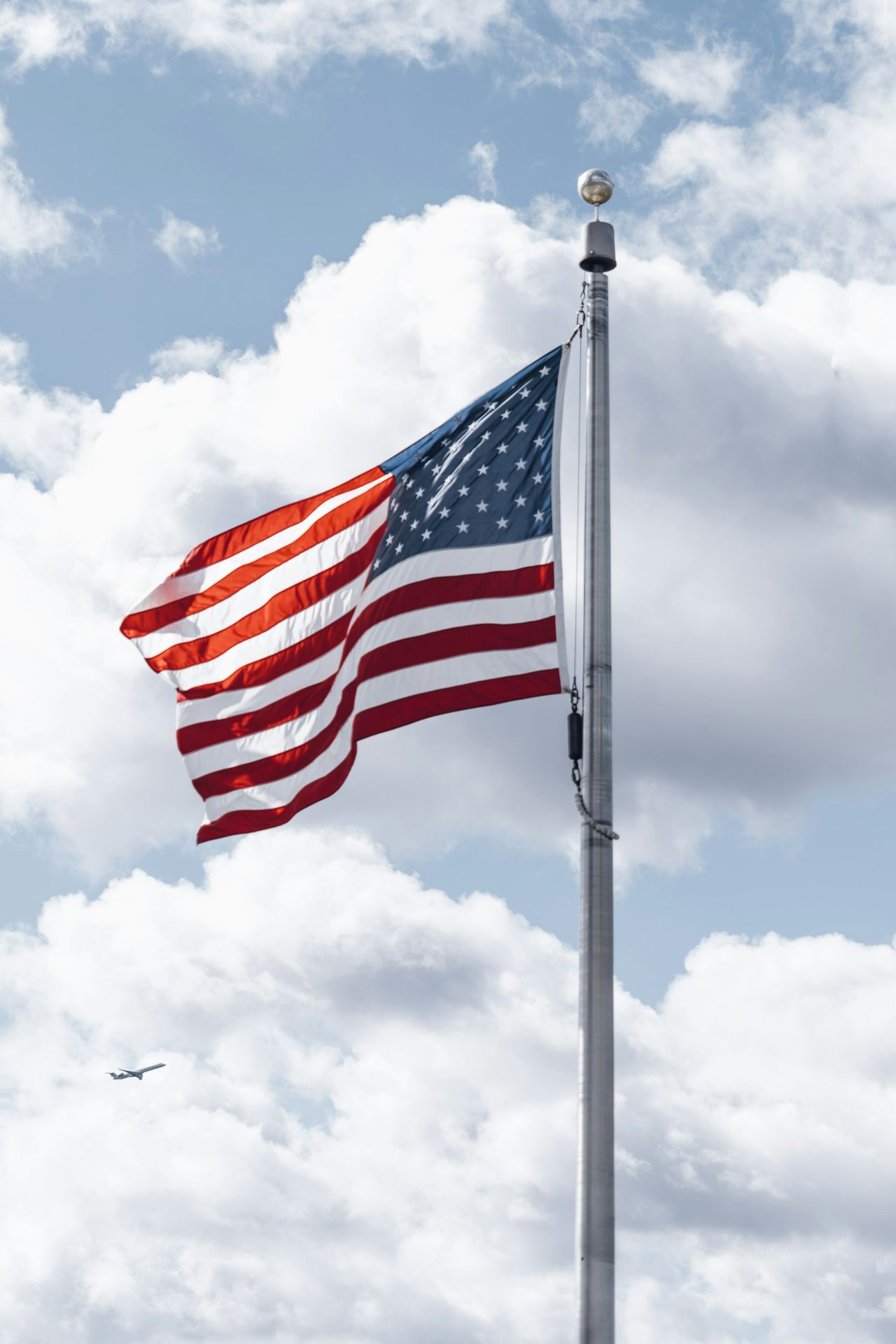 a large american flag flying in the sky